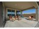Relaxing covered patio with wicker furniture and seating area at 20121 W Lilac St, Buckeye, AZ 85326