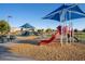 Community playground with slides and shade structures at 20121 W Lilac St, Buckeye, AZ 85326