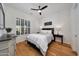 Bright bedroom with ceiling fan and wood floors at 20471 W Summit Pl, Buckeye, AZ 85396