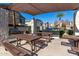 Outdoor BBQ area with tables and shaded seating at 2150 W Alameda Rd # 1388, Phoenix, AZ 85085