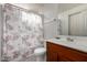 Bathroom with wooden vanity, floral shower curtain at 2150 W Alameda Rd # 1388, Phoenix, AZ 85085