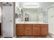 Elegant bathroom with double sinks, large mirror, and shower at 23166 W Shadow Dr, Buckeye, AZ 85326