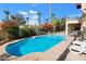 Inviting backyard pool with a volleyball net and lounge chairs at 2946 N 110Th Dr, Avondale, AZ 85392