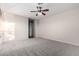 Bedroom with ceiling fan, window, and door to bathroom at 30449 N Gunderson Dr, San Tan Valley, AZ 85143