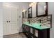 Bathroom with double sinks, glass countertop, and mosaic tile at 3301 S Goldfield Rd # 2068, Apache Junction, AZ 85119