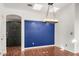 Dining room with hardwood floors and a blue accent wall at 3301 S Goldfield Rd # 2068, Apache Junction, AZ 85119