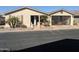 Tan single-story home with palm trees and screened carport at 3301 S Goldfield Rd # 2068, Apache Junction, AZ 85119
