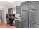 Home office with built-in gray cabinets and a workspace at 3301 S Goldfield Rd # 2068, Apache Junction, AZ 85119