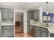 Modern kitchen with gray cabinets, granite countertops, and stainless steel appliances at 3301 S Goldfield Rd # 2068, Apache Junction, AZ 85119