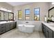 Elegant bathroom boasts double vanity, freestanding tub, and herringbone floor at 4350 E Kings Ave, Phoenix, AZ 85032