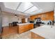 Galley kitchen with island and view into living room at 5415 W Desert Hills Dr, Glendale, AZ 85304