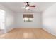 Clean bedroom with bamboo floors, a window, ceiling fan, and access to an attached bathroom at 548 N 82Nd St, Mesa, AZ 85207