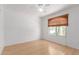 This bedroom features bamboo flooring, a ceiling fan, a window, and crisp white walls at 548 N 82Nd St, Mesa, AZ 85207