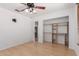 Bedroom featuring closet, utility space and bamboo floors, under the light of a ceiling fan at 548 N 82Nd St, Mesa, AZ 85207