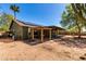 Back exterior view of a home featuring solar panels, covered patio and desert landscaping with mature trees at 548 N 82Nd St, Mesa, AZ 85207