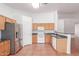 Well-lit kitchen featuring stainless steel fridge, ample countertop space, and white appliances at 548 N 82Nd St, Mesa, AZ 85207