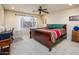 Bright bedroom with a king-size bed, work space, and ceiling fan at 6877 S Oakmont Dr, Chandler, AZ 85249