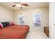 Spacious bedroom with plush carpet, large windows, and ceiling fan at 6877 S Oakmont Dr, Chandler, AZ 85249