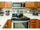 Updated kitchen features stainless steel appliances and ample counter space at 6877 S Oakmont Dr, Chandler, AZ 85249
