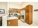 Kitchen with wood cabinets, stainless steel appliances, and tile floor at 6877 S Oakmont Dr, Chandler, AZ 85249
