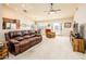 Living room with leather couches and view into kitchen and dining area at 6877 S Oakmont Dr, Chandler, AZ 85249