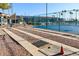 This shows shuffleboard courts for residents' enjoyment, with seating and a shaded canopy at 6877 S Oakmont Dr, Chandler, AZ 85249