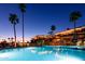 A resort-style swimming pool is illuminated at night, offering a relaxing and luxurious experience at 6877 S Oakmont Dr, Chandler, AZ 85249