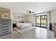 Main bedroom with king-size bed, ceiling fan, and sliding glass doors to backyard at 6936 E Friess Dr, Scottsdale, AZ 85254