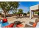Relaxing backyard patio with seating area and colorful rug at 6962 W Glenn Dr, Glendale, AZ 85303
