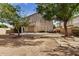 Backyard showcasing a two-story home and stone pathway at 6962 W Glenn Dr, Glendale, AZ 85303