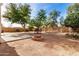 Landscaped backyard with fire pit and flagstone pathway at 6962 W Glenn Dr, Glendale, AZ 85303
