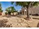 Backyard with stone path, mature trees, and a view of the house at 6962 W Glenn Dr, Glendale, AZ 85303