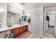 Bathroom with double vanity, and access to a walk-in closet at 6962 W Glenn Dr, Glendale, AZ 85303