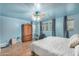 Spacious bedroom with wood flooring, king bed, and ample natural light at 6962 W Glenn Dr, Glendale, AZ 85303