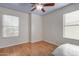 Bright bedroom with wood floors and two windows at 6962 W Glenn Dr, Glendale, AZ 85303