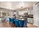 Kitchen boasts granite countertops, custom blue island, and stainless steel appliances at 6962 W Glenn Dr, Glendale, AZ 85303