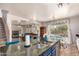 Kitchen with granite island, stainless steel appliances, and view of living room at 6962 W Glenn Dr, Glendale, AZ 85303