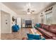 Spacious living room with a brown leather sofa and a built-in entertainment center at 6962 W Glenn Dr, Glendale, AZ 85303