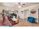 Spacious living room featuring a large leather sectional sofa and tile flooring at 6962 W Glenn Dr, Glendale, AZ 85303