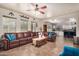 Open living room with leather sectional and views into the kitchen at 6962 W Glenn Dr, Glendale, AZ 85303