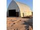 Large metal barn with open front, showing signs of wear at 735 S Ruby Rd, Maricopa, AZ 85139