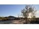 A small house with a covered patio, situated on a desert lot at 735 S Ruby Rd, Maricopa, AZ 85139