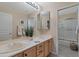 Double vanity bathroom with a large mirror and shower/tub combo at 7469 E Red Bird Rd, Scottsdale, AZ 85266