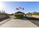 Community entrance with security gate and flags at 8103 E Southern Ave # 8, Mesa, AZ 85209