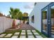 Side yard with gravel landscaping, a palm tree, and access to the back at 8709 E Irish Hunter Trl, Scottsdale, AZ 85258