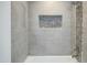 Updated bathroom with gray tile, stone accents, and a modern bathtub at 8709 E Irish Hunter Trl, Scottsdale, AZ 85258
