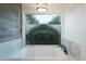 Spa-like bathroom with soaking tub, marble vanity, and large window at 8709 E Irish Hunter Trl, Scottsdale, AZ 85258