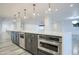Modern kitchen island with built-in microwave and dishwasher at 8709 E Irish Hunter Trl, Scottsdale, AZ 85258