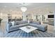 Spacious open-concept living area with modern chandelier and seamless flow into the kitchen and dining spaces at 8709 E Irish Hunter Trl, Scottsdale, AZ 85258