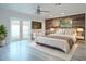 Comfortable main bedroom with a wood accent wall, outside access, and neutral decor at 8709 E Irish Hunter Trl, Scottsdale, AZ 85258